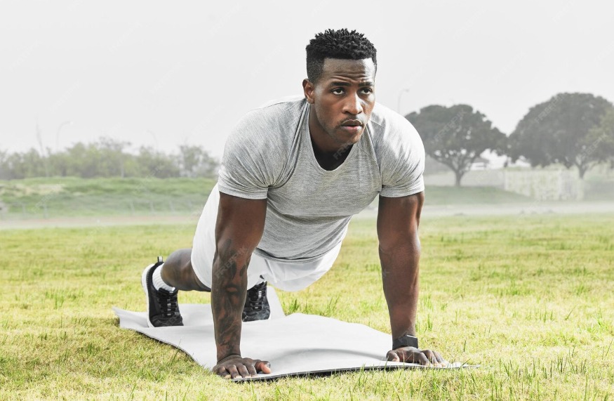 Athletic man doing stretches outdoors